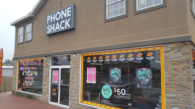 A store front with a phone shack sign in the window